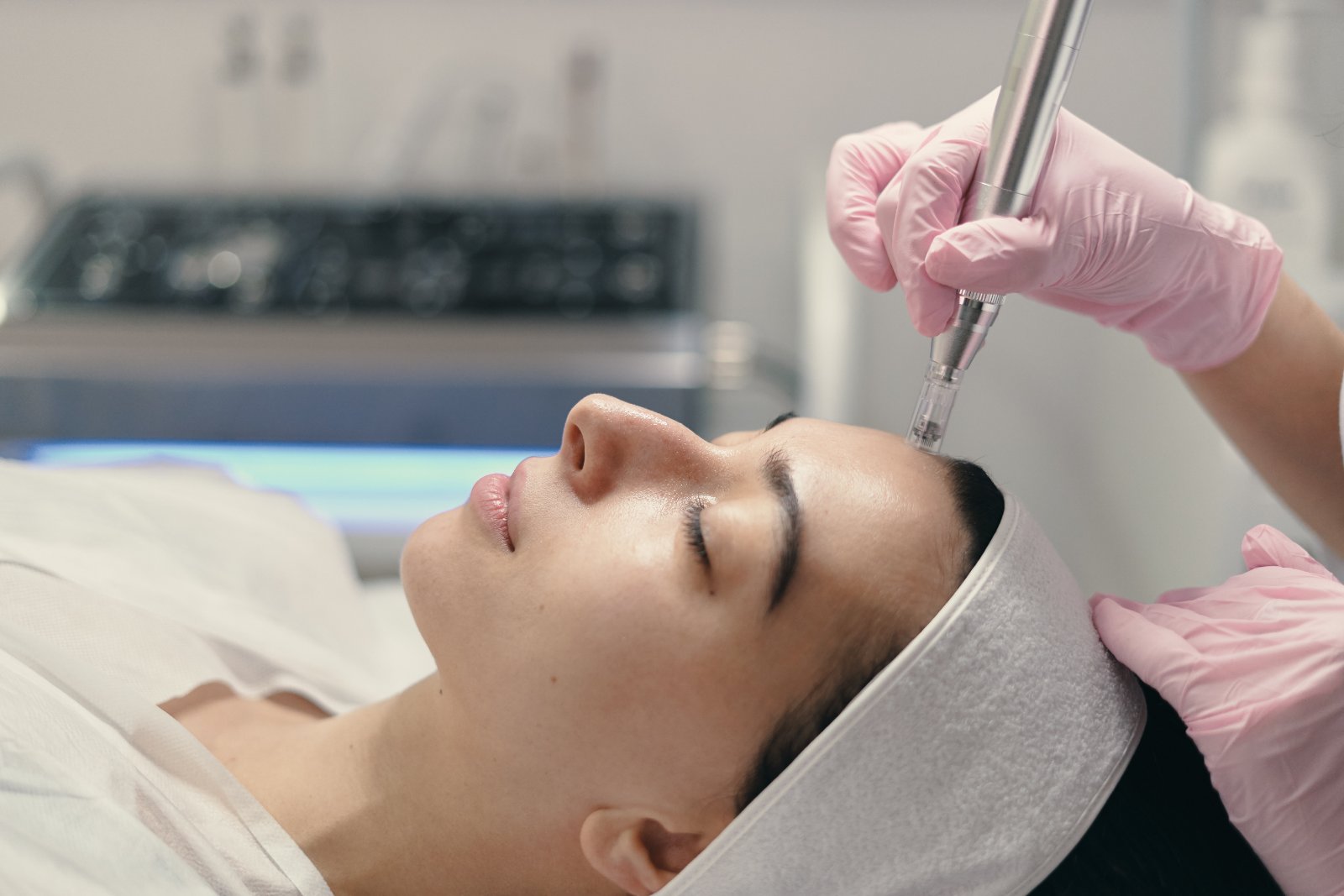 Huidtherapeut voert microneedling uit op wang met apparaat HBO-huidtherapeut behandelt wang met microneedling — behandeling voor cliënten uit Zoetermeer en omgeving